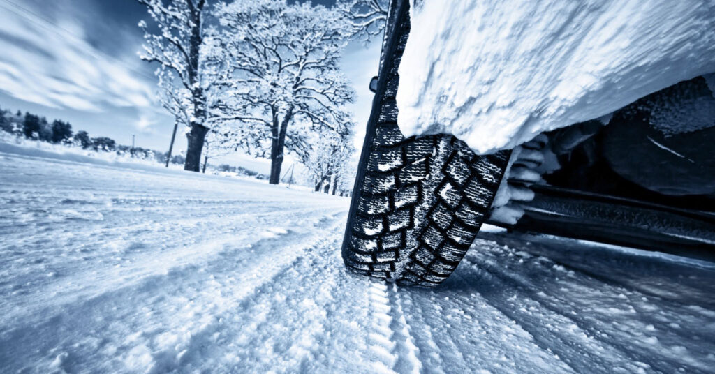 Car Tire on Snow Covered Road